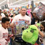 Arizona Cardinals’ Dennis Gardeck shows off the group’s toy haul during Patrick Peterson’s “Shop with a Jock” event on December 17, 2018, in Tempe, Ariz. (Tyler Drake/Arizona Sports)