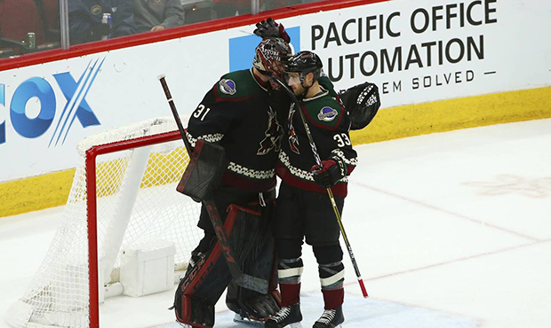 Arizona Coyotes goaltender Adin Hill (31) celebrates a win against the St. Louis Blues with Coyotes...