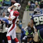 Arizona Cardinals quarterback Josh Rosen, left, passes as Seattle Seahawks' Quinton Jefferson (99) moves in during the first half of an NFL football game, Sunday, Dec. 30, 2018, in Seattle. (AP Photo/John Froschauer)
