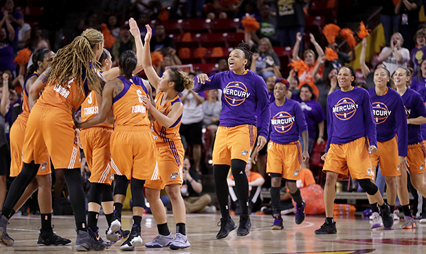 The Phoenix Mercury celebrate their 79-69 win over the Seattle Storm in a single-game WNBA basketba...
