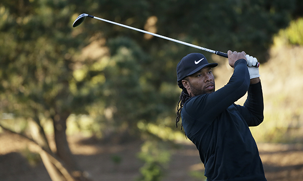 Arizona Cardnals NFL football player Larry Fitzgerald follows his drive from the first tee of the S...