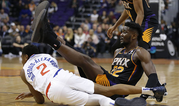 Phoenix Suns center Deandre Ayton (22) trips over Los Angeles Clippers guard Shai Gilgeous-Alexande...