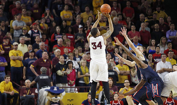 As fans look on, Arizona State's Jermaine Marshall (34) sinks a jump shot against the Arizona defen...