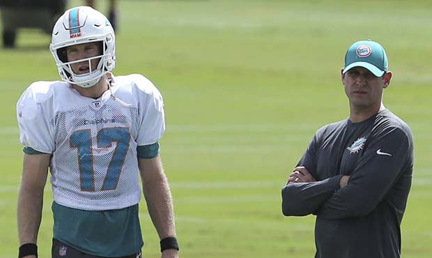 Miami Dolphins quarterback Ryan Tannehill, left, and head coach Adam Gase look on during NFL footba...