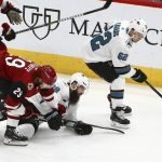 San Jose Sharks right wing Kevin Labanc (62) gets to the puck as Sharks defenseman Brent Burns, middle, gets tangled up with Arizona Coyotes right wing Mario Kempe (29) during the first period of an NHL hockey game Wednesday, Jan. 16, 2019, in Glendale, Ariz. (AP Photo/Ross D. Franklin)