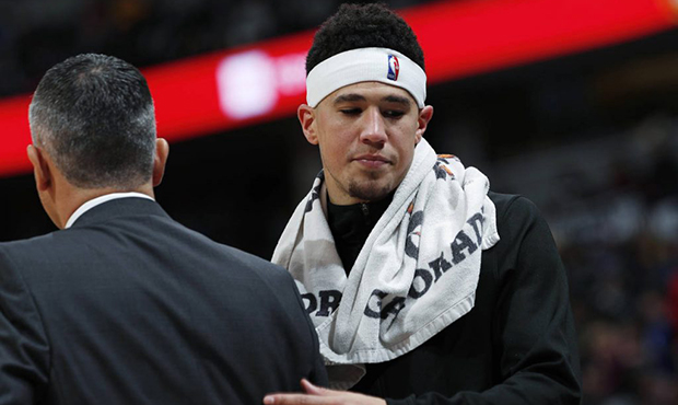 Phoenix Suns guard Devin Booker, right, confers with coach Igor Kokoskov during a timeout in the se...