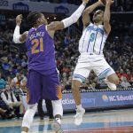 Charlotte Hornets' Tony Parker (9) shoots over Phoenix Suns' Richaun Holmes (21) during the first half of an NBA basketball game in Charlotte, N.C., Saturday, Jan. 19, 2019. (AP Photo/Chuck Burton)