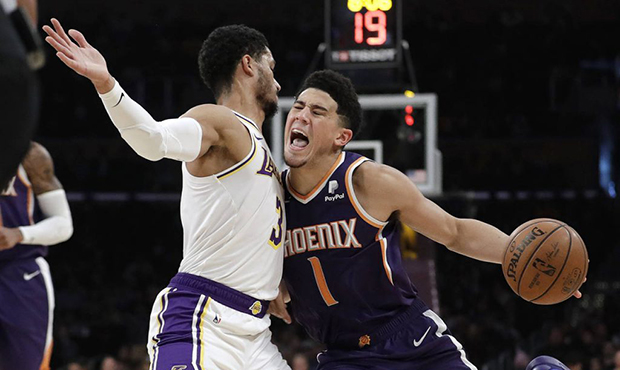 Phoenix Suns' Devin Booker (1) is defended by Los Angeles Lakers' Josh Hart (3) during the first ha...