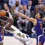 Indiana Pacers guard Victor Oladipo (4) falls backward as he works to get a shot off while being defended by Phoenix Suns guard Elie Okobo (2) during the second half of an NBA basketball game Tuesday, Jan. 15, 2019, in Indianapolis. The Pacers won 131-97. (AP Photo/Doug McSchooler)
