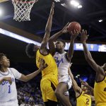 UCLA's Kris Wilkes (13) is fouled as he drives to the basket by Arizona State's De'Quon Lake, second from left, during the second half of an NCAA college basketball game Thursday, Jan. 24, 2019, in Los Angeles. (AP Photo/Marcio Jose Sanchez)