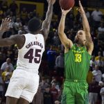 Oregon's Paul White (13) shoots over Arizona State's Zylan Cheatham (45) during the first half of an NCAA college basketball game Saturday, Jan. 19, 2019, in Tempe, Ariz. (AP Photo/Darryl Webb)