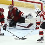 New Jersey Devils center Blake Coleman (20) sends the puck past Arizona Coyotes defenseman Alex Goligoski (33) on the way to a goal past Coyotes goaltender Darcy Kuemper (35) during the second period of an NHL hockey game Friday, Jan. 4, 2019, in Glendale, Ariz. (AP Photo/Ross D. Franklin)