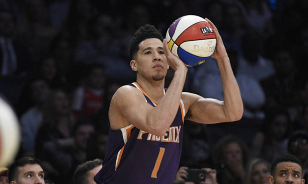 Phoenix Suns' Devin Booker shoots during the NBA basketball All-Star weekend 3-point contest Saturd...