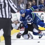 Vancouver Canucks' Jay Beagle (83) and Arizona Coyotes' Laurent Dauphin (12) collide during the first period of an NHL hockey game Thursday, Jan. 10, 2019, in Vancouver, British Columbia.(Darryl Dyck /The Canadian Press via AP)