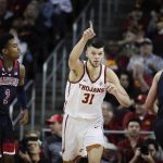 Southern California's Nick Rakocevic, center, celebrates his basket as he makes his way down the court past Arizona's Brandon Williams, left, and Ryan Luther during the second half of an NCAA college basketball game Thursday, Jan. 24, 2019, in Los Angeles. USC won 80-57. (AP Photo/Jae C. Hong)