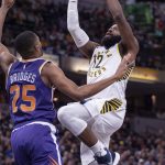 Indiana Pacers guard Tyreke Evans (12) is defended by Phoenix Suns forward Mikal Bridges (25) during the second half of an NBA basketball game Tuesday, Jan. 15, 2019, in Indianapolis. The Pacers won 131-97. (AP Photo/Doug McSchooler)