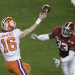 Clemson's Trevor Lawrence throws while being rushed by Alabama's Anfernee Jennings during the first half of the NCAA college football playoff championship game, Monday, Jan. 7, 2019, in Santa Clara, Calif. (AP Photo/Jeff Chiu)