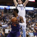 Phoenix Suns center Deandre Ayton (22) looks to shoot as Dallas Mavericks forward Luka Doncic (77) guards during the first half of an NBA basketball game, Wednesday, Jan. 9, 2019, in Dallas. (AP Photo/Jim Cowsert)
