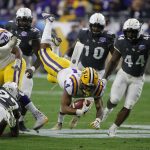 LSU running back Nick Brossette (4) dives for a first down against UCF in the first half during the Fiesta Bowl NCAA college football game, Tuesday, Jan. 1, 2019, in Glendale, Ariz. (AP Photo/Rick Scuteri)