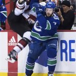 Vancouver Canucks' Tyler Motte, right, checks Arizona Coyotes' Lawson Crouse during the first period of an NHL hockey game Thursday, Jan. 10, 2019, in Vancouver, British Columbia.(Darryl Dyck /The Canadian Press via AP)