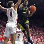 Oregon guard Victor Bailey Jr. (10) drives on Arizona center Chase Jeter in the first half of an NCAA college basketball game, Thursday, Jan. 17, 2019, in Tucson, Ariz. (AP Photo/Rick Scuteri)