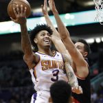Phoenix Suns forward Kelly Oubre Jr. (3) shoots around Portland Trail Blazers forward Zach Collins during the first half of an NBA basketball game Thursday, Jan. 24, 2019, in Phoenix. (AP Photo/Matt York)
