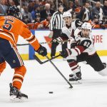 Arizona Coyotes ' Jordan Oesterle (82) shoots as Edmonton Oilers' Kevin Gravel (5) defends during the first period of an NHL hockey game Saturday, Jan. 12, 2019, in Edmonton Alberta. (Jason Franson/The Canadian Press via AP)