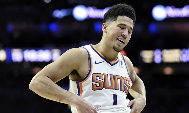 Phoenix Suns' Devin Booker (1) reacts to a foul call in the second half of an NBA basketball game a...