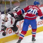Arizona Coyotes defenseman Jordan Oesterle (82) is checked by Montreal Canadiens left wing Nicolas Deslauriers (20) during the first period of an NHL hockey game Wednesday, Jan. 23, 2019, in Montreal. (Ryan Remiorz/The Canadian Press via AP)