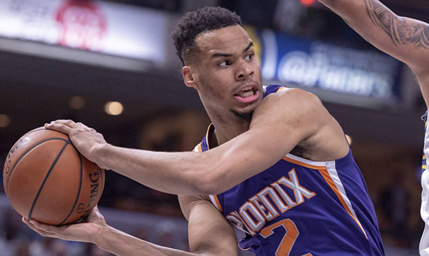 Phoenix Suns guard Elie Okobo (2) prepares to pass the ball to a teammate from the baseline during ...