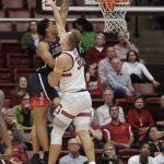 Arizona forward Ira Lee, left, dunks against Stanford forward Lukas Kisunas during the first half of an NCAA college basketball game in Stanford, Calif., Wednesday, Jan. 9, 2019. (AP Photo/Jeff Chiu)