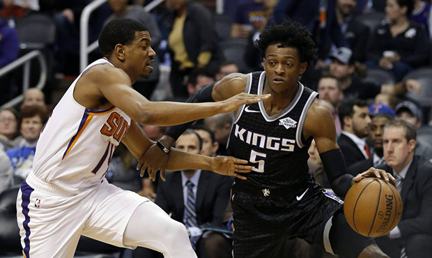 Sacramento Kings guard De'Aaron Fox (5) drives on Phoenix Suns guard De'Anthony Melton in the first...