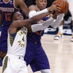 Indiana Pacers guard Victor Oladipo (4) competes for the ball with Phoenix Suns forward Richaun Holmes (21) during the second half of an NBA basketball game Tuesday, Jan. 15, 2019, in Indianapolis. The Pacers won 131-97. (AP Photo/Doug McSchooler)