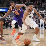 San Antonio Spurs' Rudy Gay (22) and LaMarcus Aldridge, left, and Phoenix Suns' Josh Jackson chase the ball during the second half of an NBA basketball game Tuesday, Jan. 29, 2019, in San Antonio. San Antonio won 126-124. (AP Photo/Darren Abate)