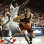 Oregon State forward Tres Tinkle drives past Arizona guard Dylan Smith (3) during the first half of an NCAA college basketball game Saturday, Jan. 19, 2019, in Tucson, Ariz. (AP Photo/Rick Scuteri)