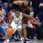 Arizona guard Justin Coleman (12) shields Oregon State guard Ethan Thompson from the ball in the second half during an NCAA college basketball game Saturday, Jan. 19, 2019, in Tucson, Ariz. Arizona defeated Oregon State 82-71. (AP Photo/Rick Scuteri)