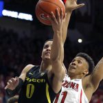 Oregon guard Will Richardson (0) shoots in front of Arizona forward Ira Lee in the first half of an NCAA college basketball game, Thursday, Jan. 17, 2019, in Tucson, Ariz. (AP Photo/Rick Scuteri)