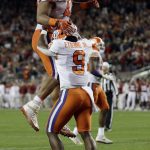 Clemson's Travis Etienne is congratulated by Christian Wilkins (42) after his touchdown during the first half of the NCAA college football playoff championship game against Alabama Monday, Jan. 7, 2019, in Santa Clara, Calif. (AP Photo/David J. Phillip)