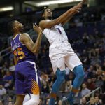 Charlotte Hornets guard Malik Monk (1) drives past Phoenix Suns forward Mikal Bridges in the first half during an NBA basketball game, Sunday, Jan. 6, 2019, in Phoenix. (AP Photo/Rick Scuteri)