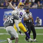 LSU quarterback Joe Burrow (9) throws over the top of UCF defensive back Kyle Gibson in the first half during the Fiesta Bowl NCAA college football game, Tuesday, Jan. 1, 2019, in Glendale, Ariz. Gibson was ejected on the play for a late hit on Burrow. (AP Photo/Rick Scuteri)