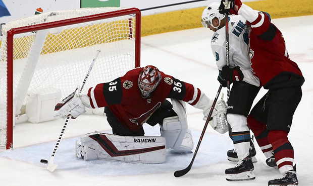 Arizona Coyotes goaltender Darcy Kuemper (35) makes a save on a shot from San Jose Sharks left wing...