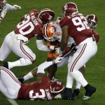 Clemson's Travis Etienne is stopped during the first half the NCAA college football playoff championship game against Alabama, Monday, Jan. 7, 2019, in Santa Clara, Calif. (AP Photo/Jeff Chiu)