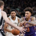Phoenix Suns' Kelly Oubre, Jr. (3) loses the ball as he drives against San Antonio Spurs' Jakob Poeltl, left, and Rudy Gay during the first half of an NBA basketball game, Tuesday, Jan. 29, 2019, in San Antonio. (AP Photo/Darren Abate)