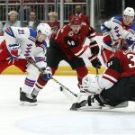 New York Rangers center Brett Howden (21) plays the puck in front of Arizona Coyotes goalie Darcy Kuemper (35) as Arizona Coyotes' Ilya Lyubushkin (46) defends during the first period of an NHL hockey game, Sunday, Jan. 6, 2019, in Glendale, Ariz. (AP Photo/Ralph Freso)