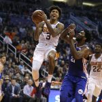 Phoenix Suns forward Kelly Oubre Jr. (3) drives past Philadelphia 76ers center Joel Embiid (21) in the first half during an NBA basketball game, Wednesday, Jan. 2, 2019, in Phoenix. (AP Photo/Rick Scuteri)