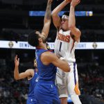 Phoenix Suns guard Devin Booker, right, goes up to shoot as Denver Nuggets forward Trey Lyles defends in the first half of an NBA basketball game Friday, Jan. 25, 2019, in Denver. (AP Photo/David Zalubowski)