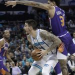 Phoenix Suns' Kelly Oubre Jr. (3) fouls Charlotte Hornets' Willy Hernangomez (41) during the first half of an NBA basketball game in Charlotte, N.C., Saturday, Jan. 19, 2019. (AP Photo/Chuck Burton)