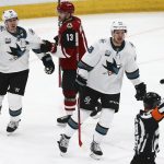 San Jose Sharks center Tomas Hertl (48) and center Logan Couture (39) argue a tripping penalty called by referee Tom Chmielewski, right, against Couture as Arizona Coyotes center Vinnie Hinostroza (13) holds Couture back during the third period of an NHL hockey game Wednesday, Jan. 16, 2019, in Glendale, Ariz. The Coyotes defeated the Sharks 6-3. (AP Photo/Ross D. Franklin)