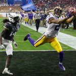 LSU wide receiver Justin Jefferson (2) makes a touchdown catch against UCF defensive back Nevelle Clarke (14) during the first half of a Fiesta Bowl NCAA college football game Tuesday, Jan. 1, 2019, in Glendale, Ariz. (AP Photo/Ross D. Franklin)