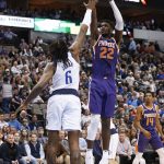 Phoenix Suns center Deandre Ayton (22) shoots over Dallas Mavericks center DeAndre Jordan (6) during the first half of an NBA basketball game, Wednesday, Jan. 9, 2019, in Dallas. (AP Photo/Jim Cowsert)